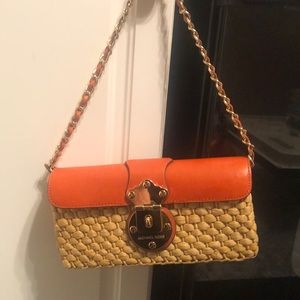 Authentic Michael Kors straw and leather clutch.